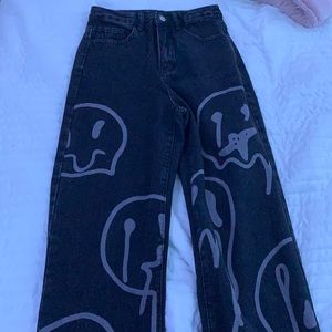 black jeans with smiley faces